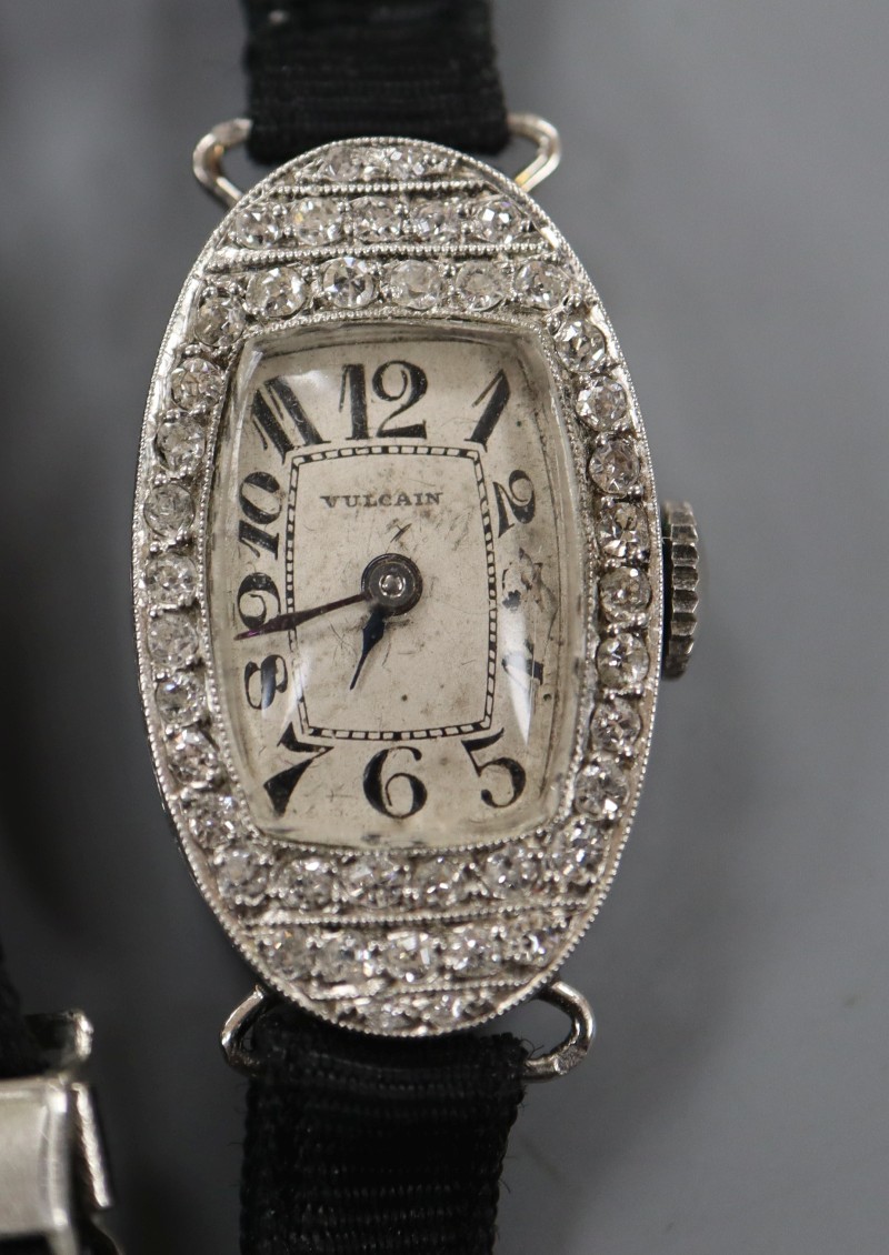 A ladys French 1930s/1940s white metal (inscribed Platine) and diamond set oval cocktail watch, on fabric strap.